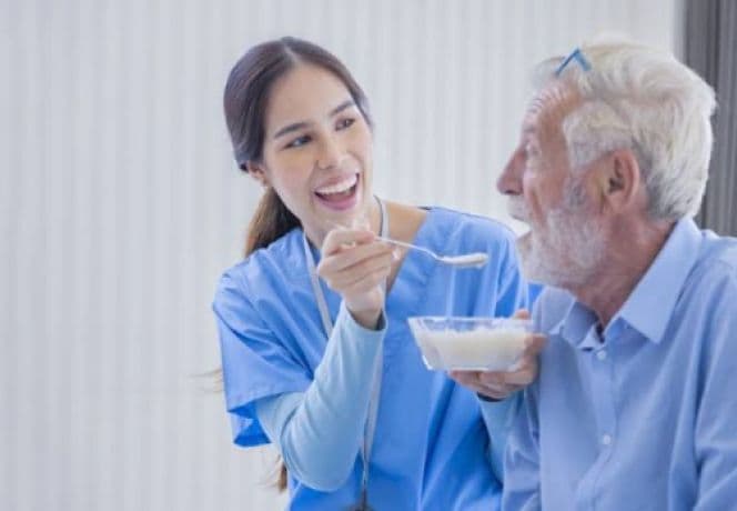 Support worker preparing a meal with a participant