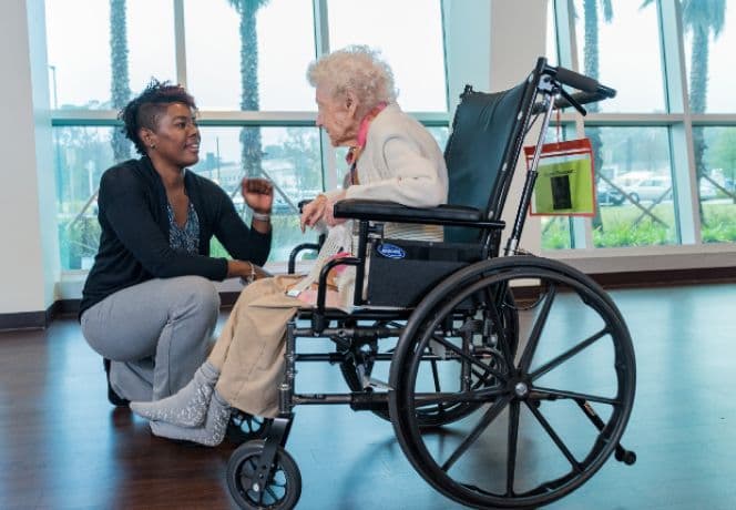 Carer and participant enjoying time outdoors together
