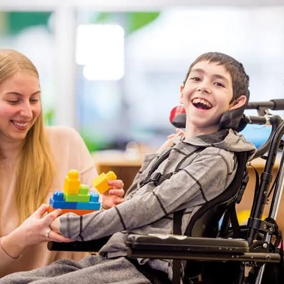Support worker playing with a young participant